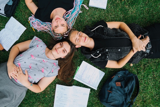 students lay on grass