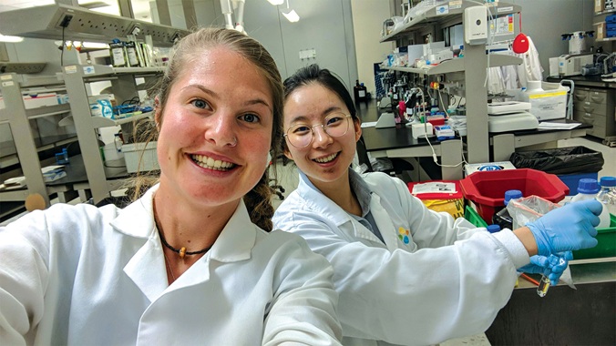 two happy students in lab